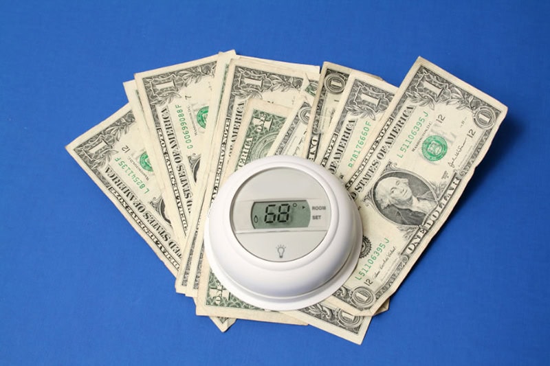 thermostat sitting on cash.