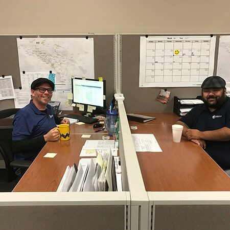 Airplus of California employees at their desks in the Corona, CA office.